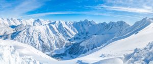 Wide panoramic view of winter landscape with snow covered Alps i